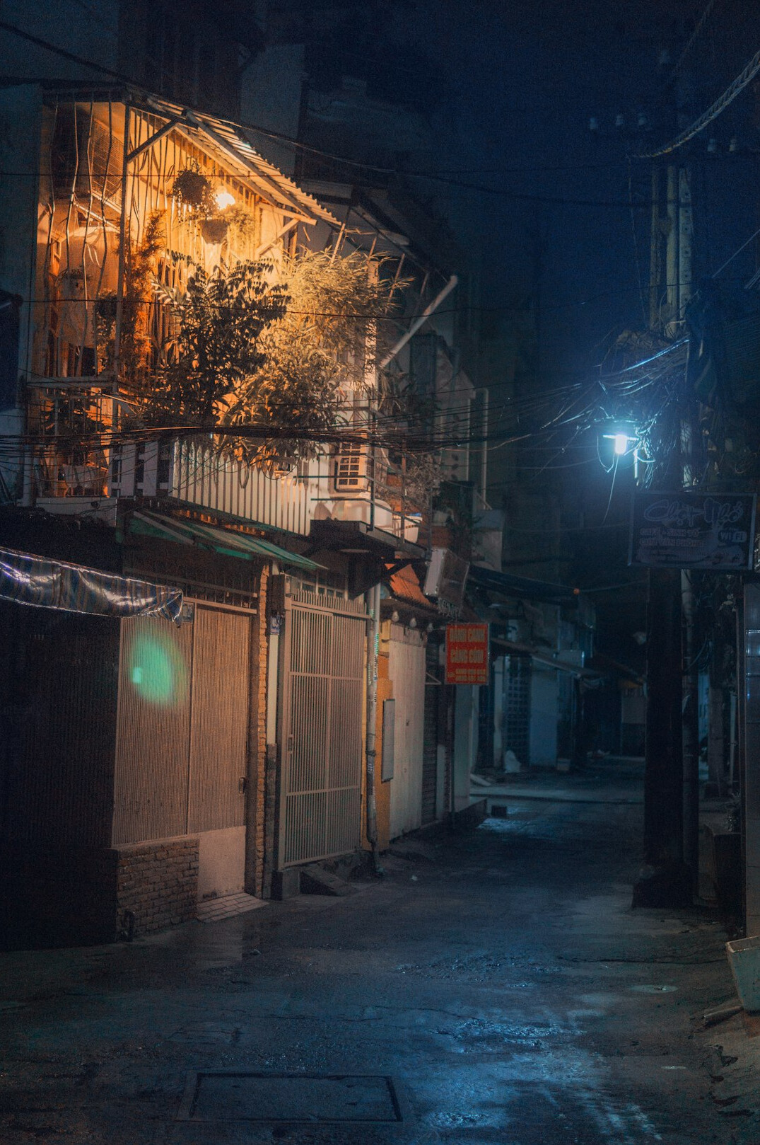 Empty city street at night with warm street lights