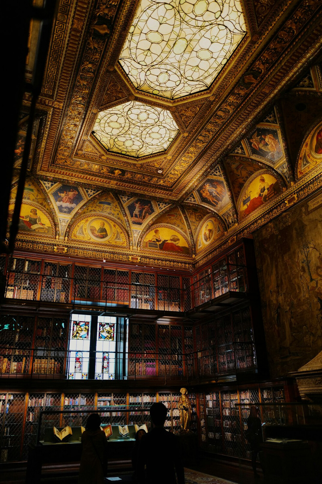 Old library with tall bookshelves and warm light
